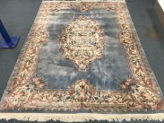 Large Chinese washed woollen blue ground rug, central medallion and overall floral design,