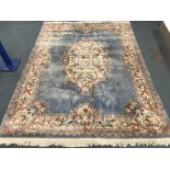 Large Chinese washed woollen blue ground rug, central medallion and overall floral design,