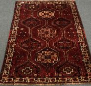Persian red ground rug, geometric pattern field, repeating border,