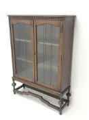 Early 20th century oak bookcase, two lead glazed doors enclosing two shelves,