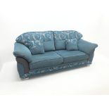 Three seat sofa upholstered in a blue and grey fabric,