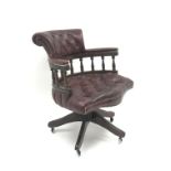 Swivel captains desk chair upholstered in deep buttoned ox blood leather,