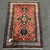 Persian style red and blue ground rug, repeating border,