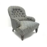 Victorian spoon back armchair, upholstered in a deep buttoned patterned fabric, turned supports,