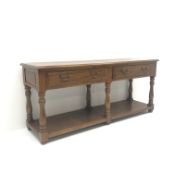 20th century medium oak dresser base, moulded top above two drawers,