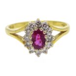 18ct gold oval ruby and round brilliant cut diamond cluster ring,