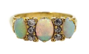 Edwardian 18ct gold three stone oval opal and six stone diamond ring,