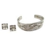 Silver contemporary design bangle and matching earrings,