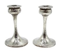 Pair of silver Arts & Crafts candlesticks, spot hammered decoration by S Blanckensee & Son Ltd,