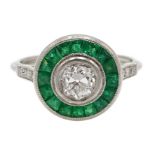 Platinum old cut diamond and calibre cut emerald target ring, with diamond set shoulders,