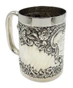 Silver christening mug embossed floral decoration with later engraved cartouche by E S Barnsley &