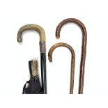 An ebonised, silver mounted, horn handled walking cane,