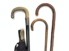 An ebonised, silver mounted, horn handled walking cane,