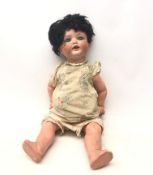 A German Armand Marseille bisque headed doll, with sleeping eyes and composition limbs,