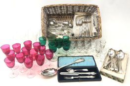 Selection of late Victorian and later cranberry and green glass wine glasses on clear glass stems,