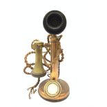 An early 20th century brass stick telephone, with Bakelite mouth and ear piece, H31cm.