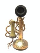 An early 20th century brass stick telephone, with Bakelite mouth and ear piece, H31cm.