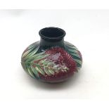 A small Moorcroft vase, of squat bulbous form, decorated with flowers and foliage,