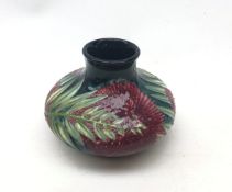 A small Moorcroft vase, of squat bulbous form, decorated with flowers and foliage,