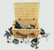 Wicker basket containing various fishing reels including Masterline 'Toothy Critter',