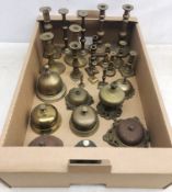 Collection of 19th century and later brass candlesticks and counter bells of varying shape and size,