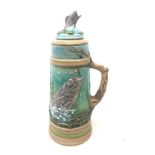 Large earthenware stein moulded with a continuous underwater landscape of fish amongst grasses and