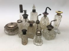 Assorted Victorian and later cut glass scent bottles and atomizers, mostly with silver mounts,