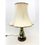 A large Moorcroft table lamp, decorated in the Lamia pattern, with bulrushes and water lilies,