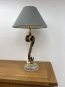 Large gilt and simulated stone 'S' form table lamp on a stepped polished stone effect base,