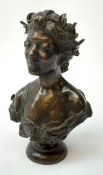 A bronze bust modelled as a female, raised upon a socle base, marked to back, H18cm.
