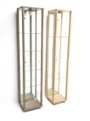 Two illuminated tall floor standing display cabinets with adjustable glass shelves, (36cm x 33cm,