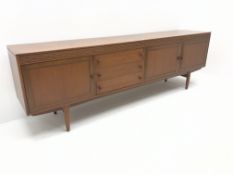 Mid century teak sideboard, three cupboards and three drawers, turned tapering supports, W229cm,