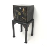 Early 20th century Chinoiserie ebonised cabinet on stand, two doors, square tapering supports,