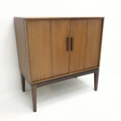 Mid century teak cabinet, two bi-fold doors enclosing single shelf on stand, W78cm, H83cm,