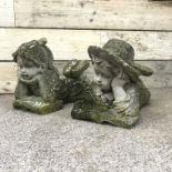 Pair composite stone figures of a boy and girl in prone position reading, H34cm,