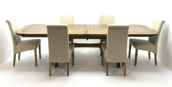 Light oak dining table, extending pull out action top with rounded corners, two fold out leaves,