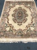 Chinese beige ground rug with central medallion,