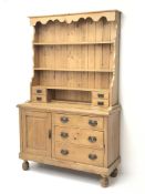 Victorian waxed pine dresser, shaped frieze above three tier plate rack with four small drawers,