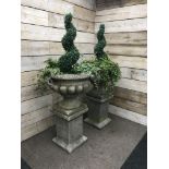 Pair large composite stone twin handled garden urns on square column plinths (planted),