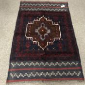 Baluchi dark blue ground rug, central motif,