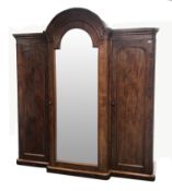 Victorian mahogany triple breakfront wardrobe with arched top, projecting cornice,