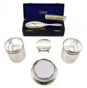 Silver lidded jewellery box raised on four legs and silver mounted glass dressing table jars by Jame