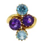 Edwardian 18ct gold four stone blue zircon and amethyst crossover ring, makers mark HPH, Birmingham