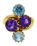 Edwardian 18ct gold four stone blue zircon and amethyst crossover ring, makers mark HPH, Birmingham