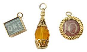 Three 9ct gold charms, two currency and an orange glass one, all hallmarked