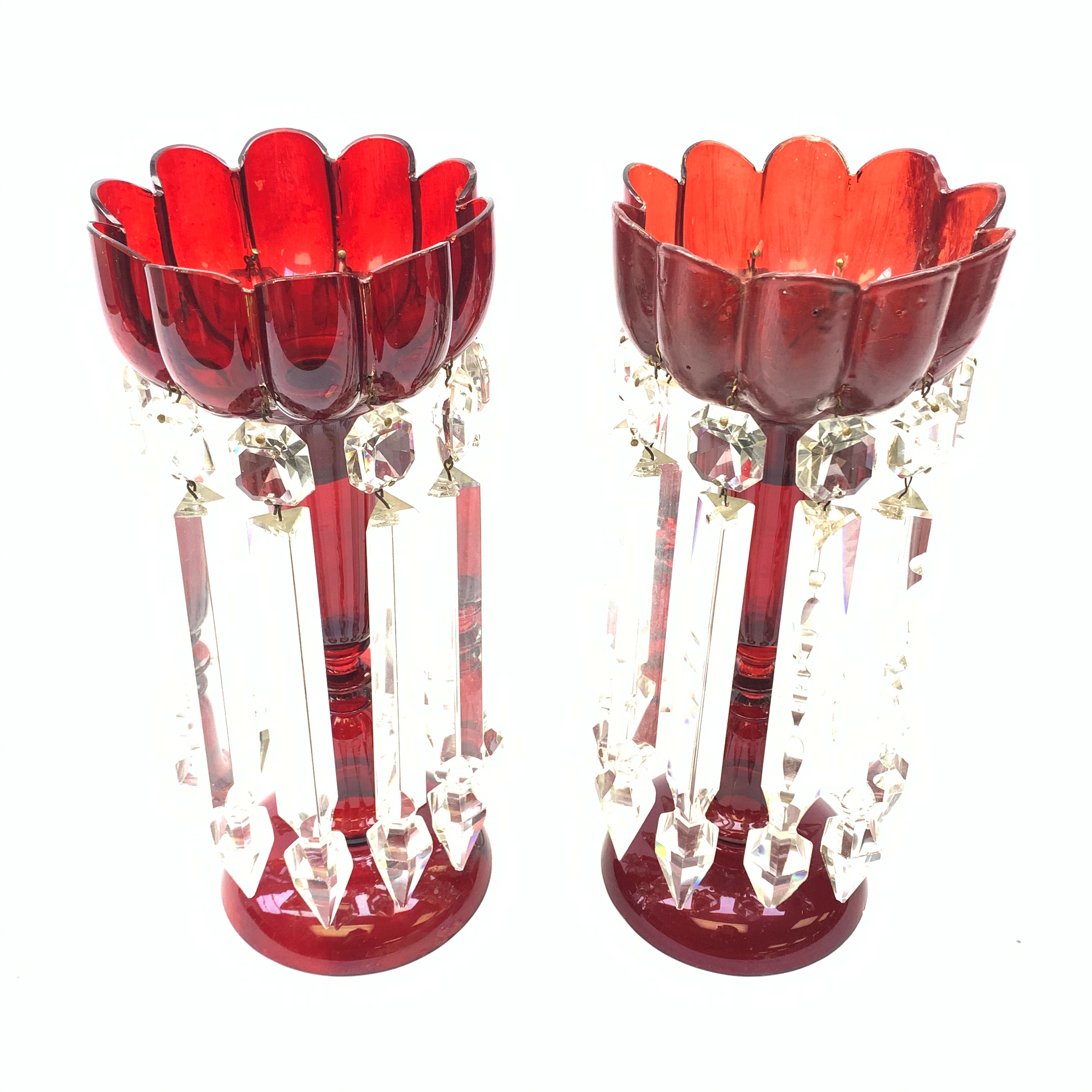 A pair of red glass lustres, each supporting ten clear cut glass droppers (one restored), together w