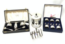 A cased silver plated set of six napkin rings and menu holders modelled as swans, together with a c
