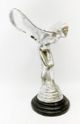 A cast Rolls Royce Spirit of Ecstasy car mascot, raised upon a circular stepped wooden base, H36cm.