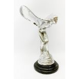 A cast Rolls Royce Spirit of Ecstasy car mascot, raised upon a circular stepped wooden base, H36cm.