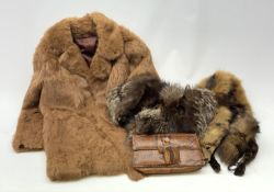 A three quarter length lined fur coat, together with two fox stoles, and a snake skin purse.